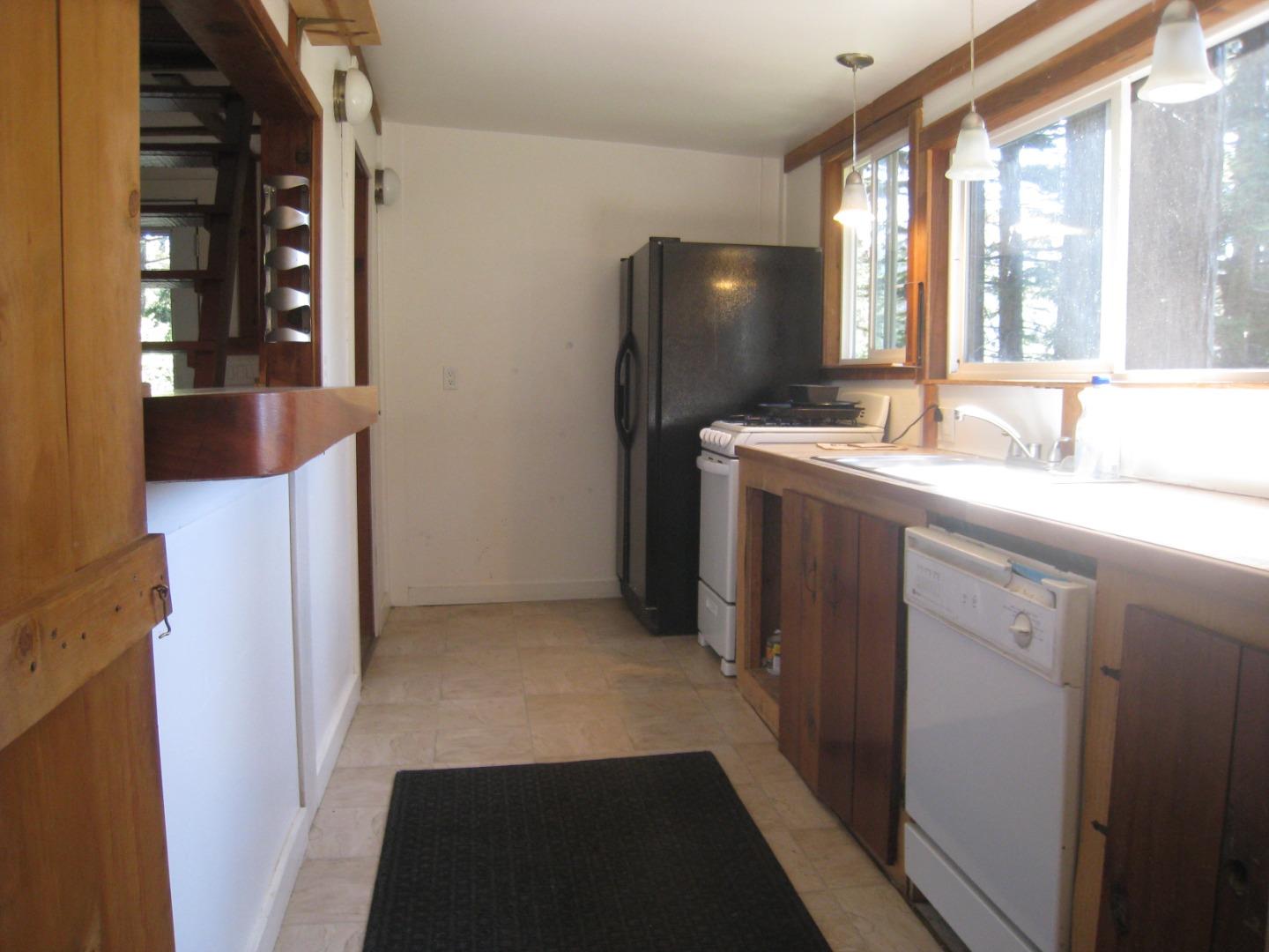 347 Ridge Road Woodside, CA 94062 - Photo 9 of 20 a kitchen with a sink and a refrigerator