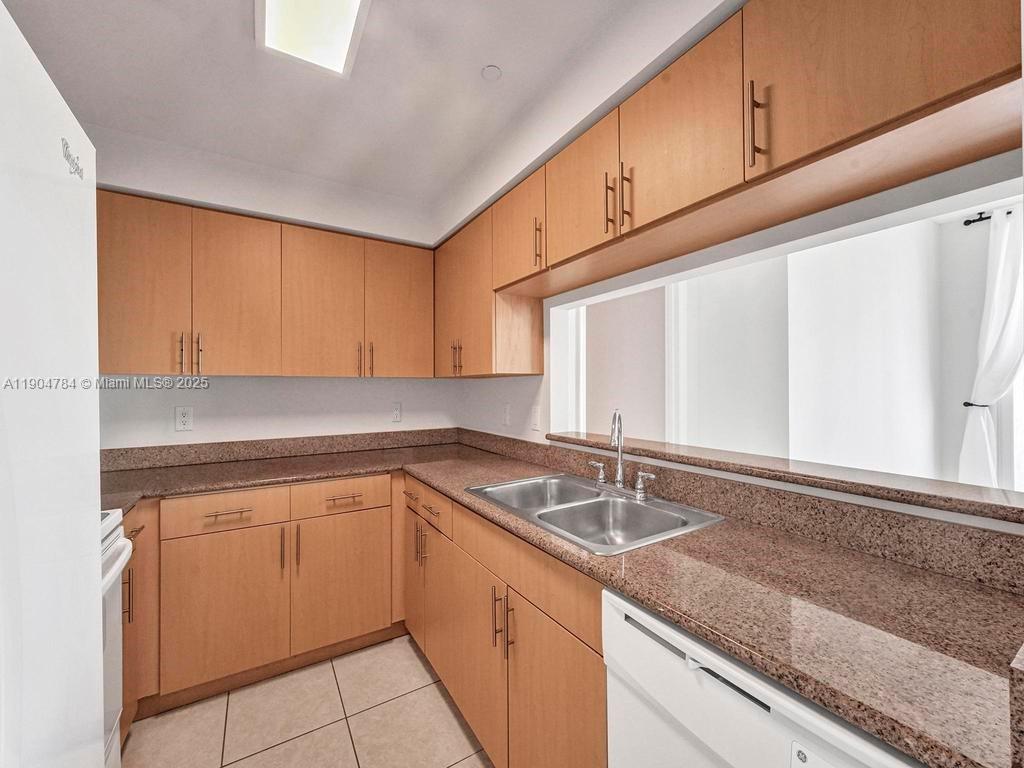 2475 Brickell Avenue, Unit 2006 Miami, FL 33129 - Photo 14 of 61 a kitchen with granite countertop a sink and a stove
