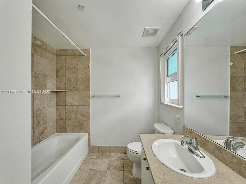 2475 Brickell Avenue, Unit 2006 Miami, FL 33129 - Photo 26 of 61 a bathroom with a granite countertop sink a toilet and shower