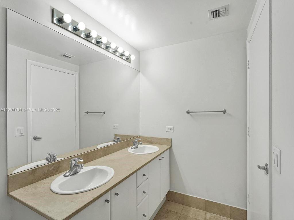 2475 Brickell Avenue, Unit 2006 Miami, FL 33129 - Photo 30 of 61 a bathroom with a sink and a mirror
