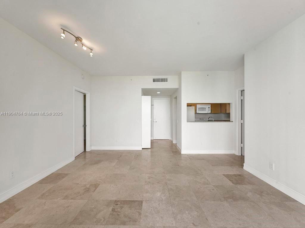 2475 Brickell Avenue, Unit 2006 Miami, FL 33129 - Photo 34 of 61 a view of a big room with wooden floor and kitchen