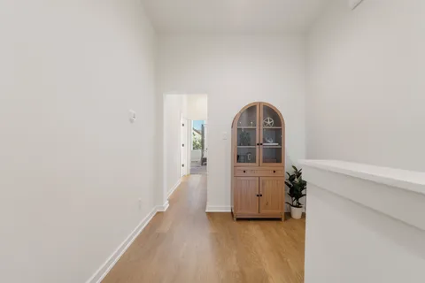 a view of a room with wooden floor and cabinet