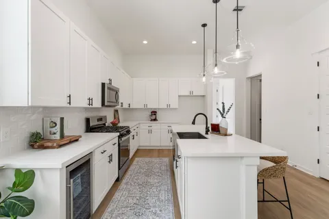 a kitchen with stainless steel appliances a stove sink and cabinets
