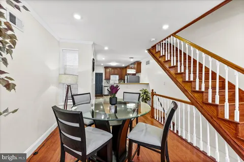 a dining room with furniture and wooden floor