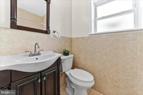 a bathroom with a sink a toilet and mirror