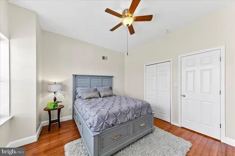 a bedroom with a bed chandelier and a window