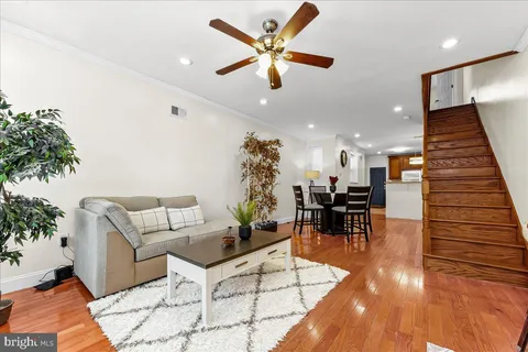 a living room with furniture and wooden floor
