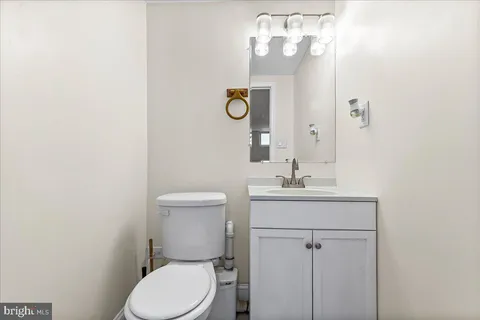 a bathroom with a sink a toilet and mirror