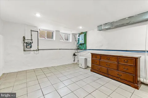 a room with a baby crib and a dresser