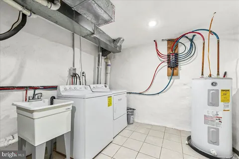a utility room with cabinets a washer and dryer