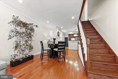 a dining room with furniture and wooden floor