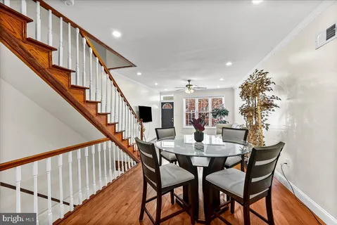 a view of a dining room with furniture and wooden floor