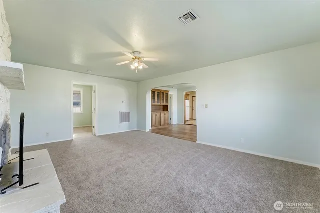 a view of an empty room with a fireplace