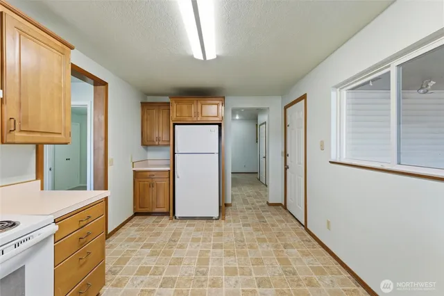 a kitchen with a refrigerator and a stove