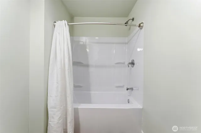 a view of storage and utility room with wooden floor