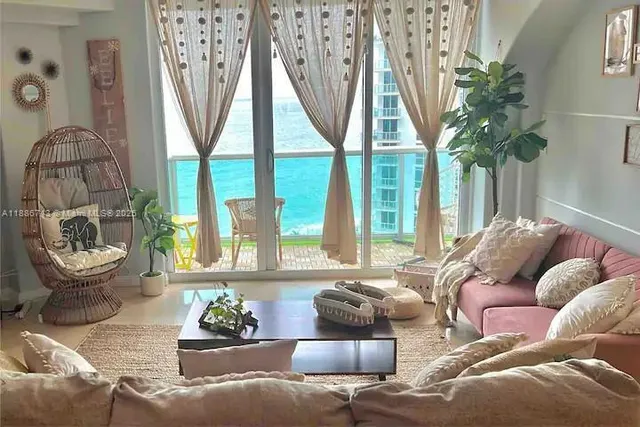 a living room with furniture and a large window