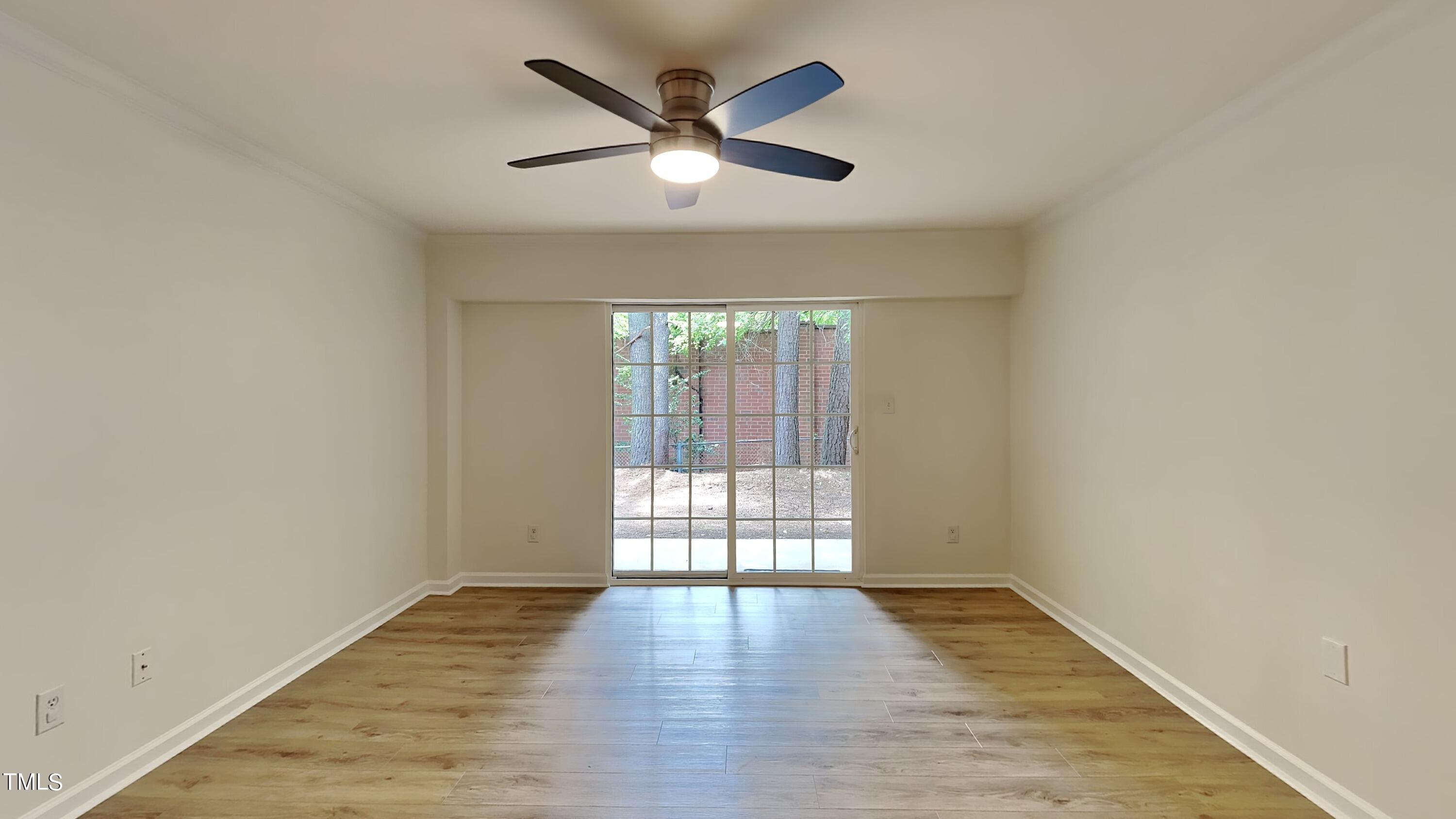 2300 Myron Drive, Unit 3 Raleigh, NC 27607 - Photo 3 of 12 an empty room with wooden floor and windows