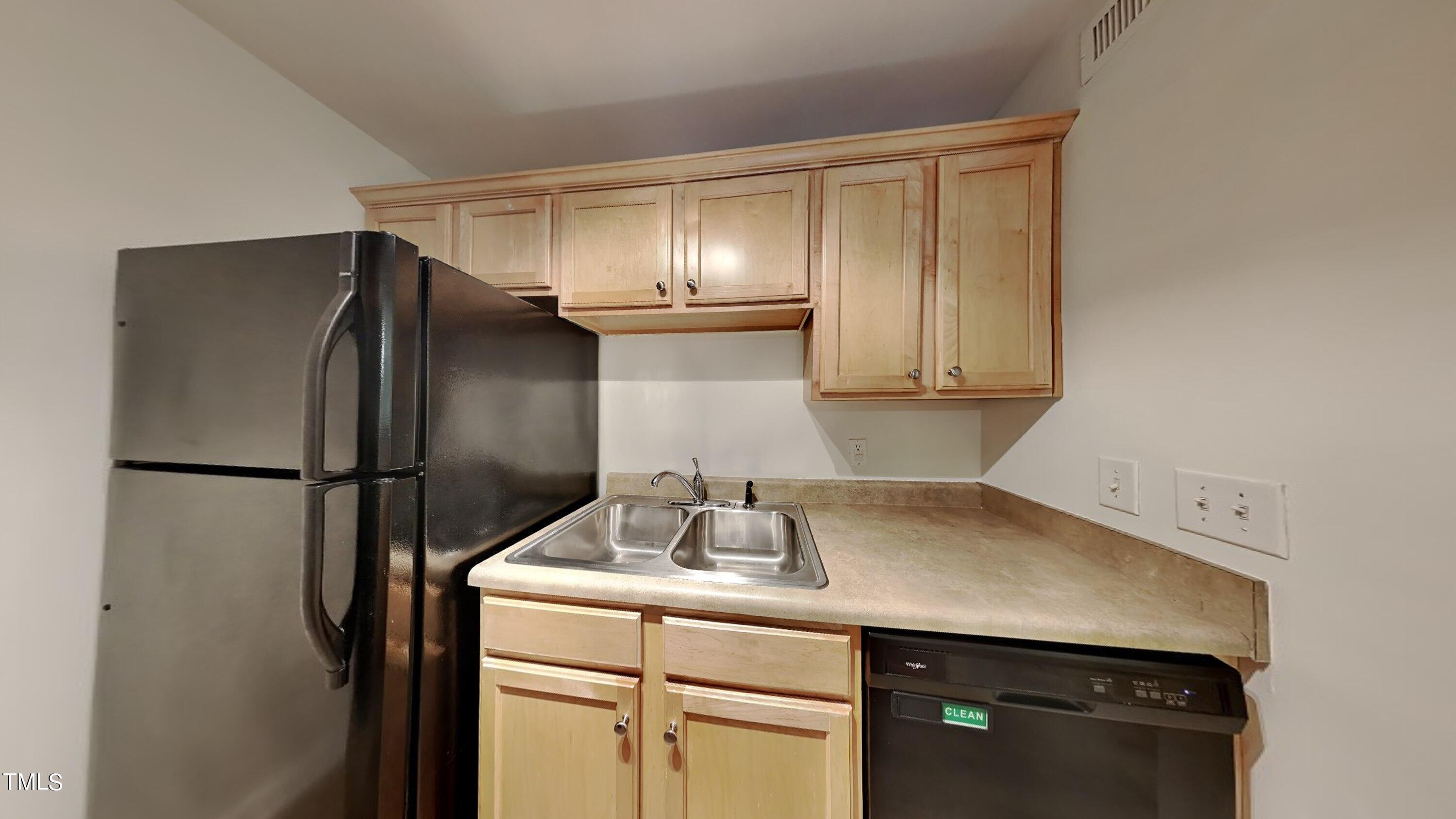 2300 Myron Drive, Unit 3 Raleigh, NC 27607 - Photo 4 of 12 a kitchen with a sink and a refrigerator