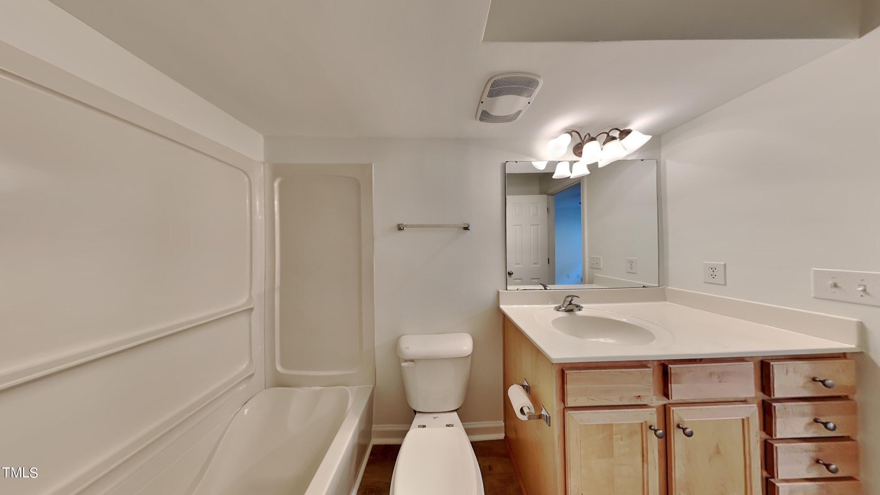 2300 Myron Drive, Unit 3 Raleigh, NC 27607 - Photo 8 of 12 a bathroom with a sink and a mirror