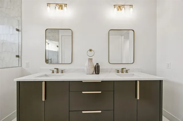a bathroom with a double vanity sink and a mirror
