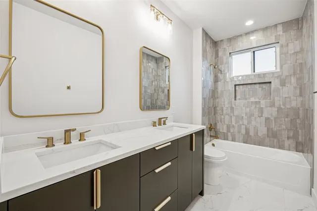 a bathroom with a double vanity sink mirror double and bathtub