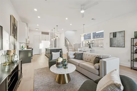 a living room with furniture and a view of kitchen