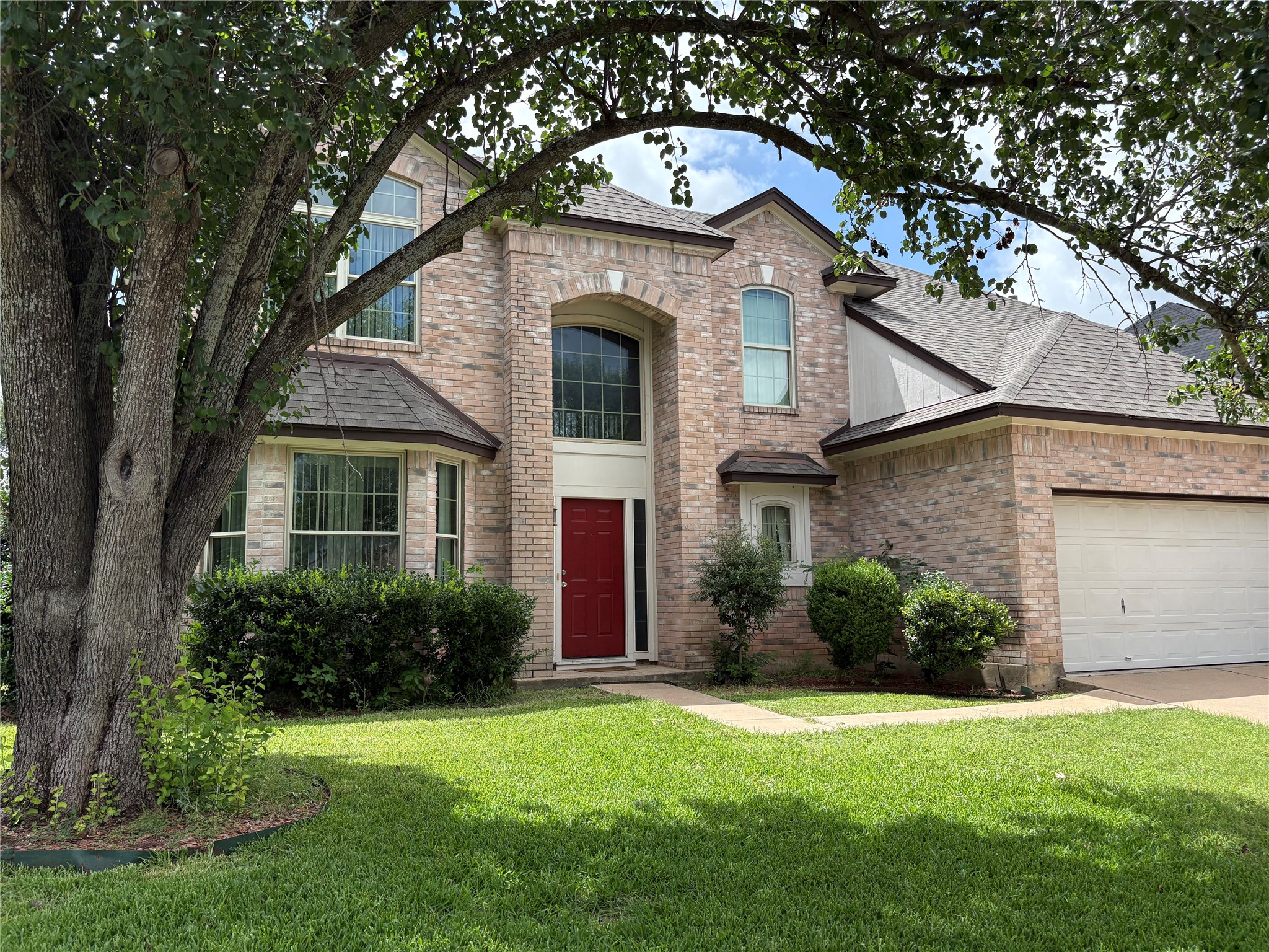 8103 Ephraim Road Austin, TX 78717 - Photo 1 of 35 Timeless brick exterior with an arched entryway and welcoming red front door.
