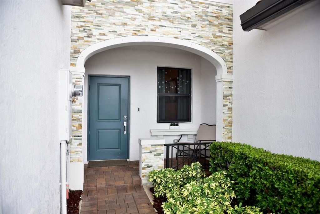 Princeton Homestead, FL 33032 - Photo 2 of 28 a front view of a house with garden