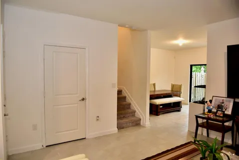 a view of a livingroom with furniture and a window