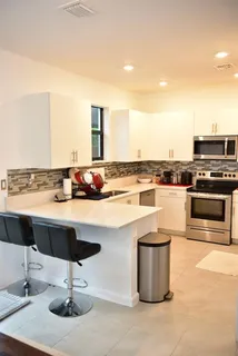 a kitchen with a sink stainless steel appliances and cabinets