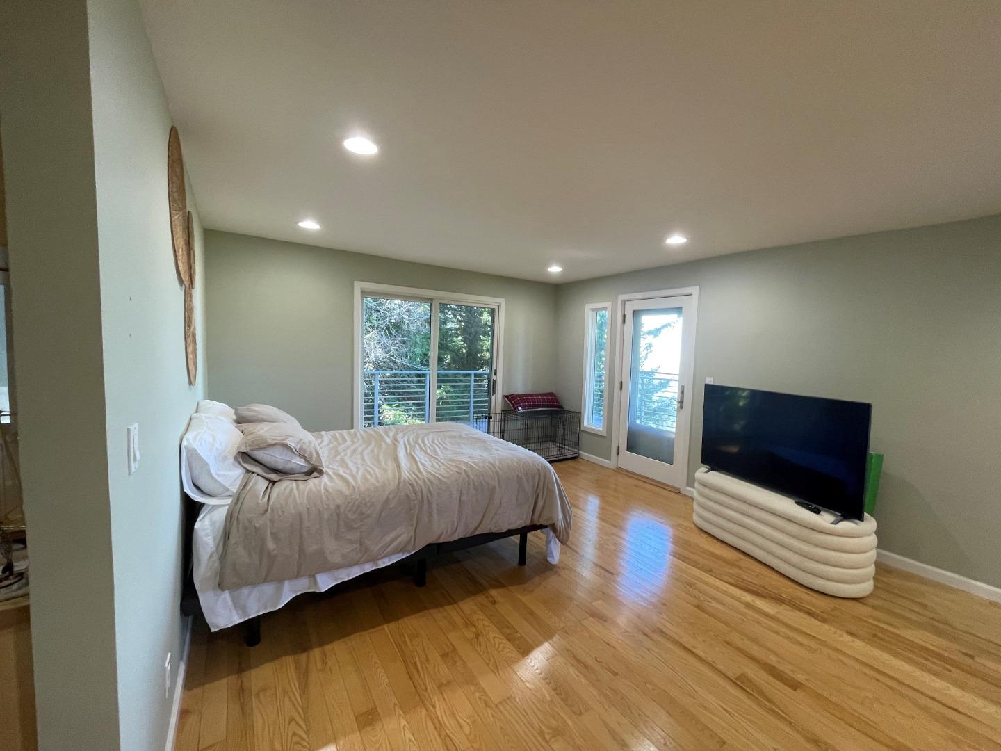254 Swett Road Woodside, CA 94062 - Photo 13 of 31 a bedroom with a bed and wooden floor