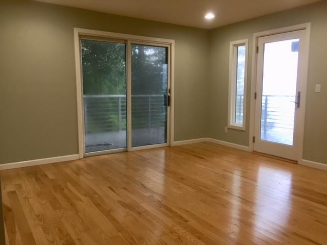 254 Swett Road Woodside, CA 94062 - Photo 17 of 31 an empty room with wooden floor and windows
