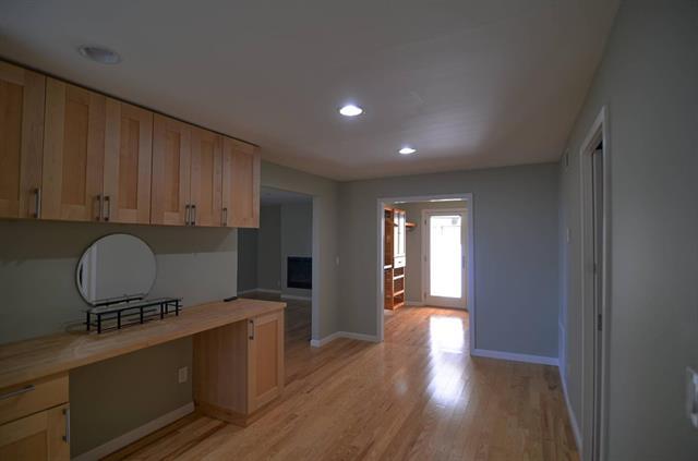 254 Swett Road Woodside, CA 94062 - Photo 20 of 31 a kitchen with wooden cabinets and black appliances