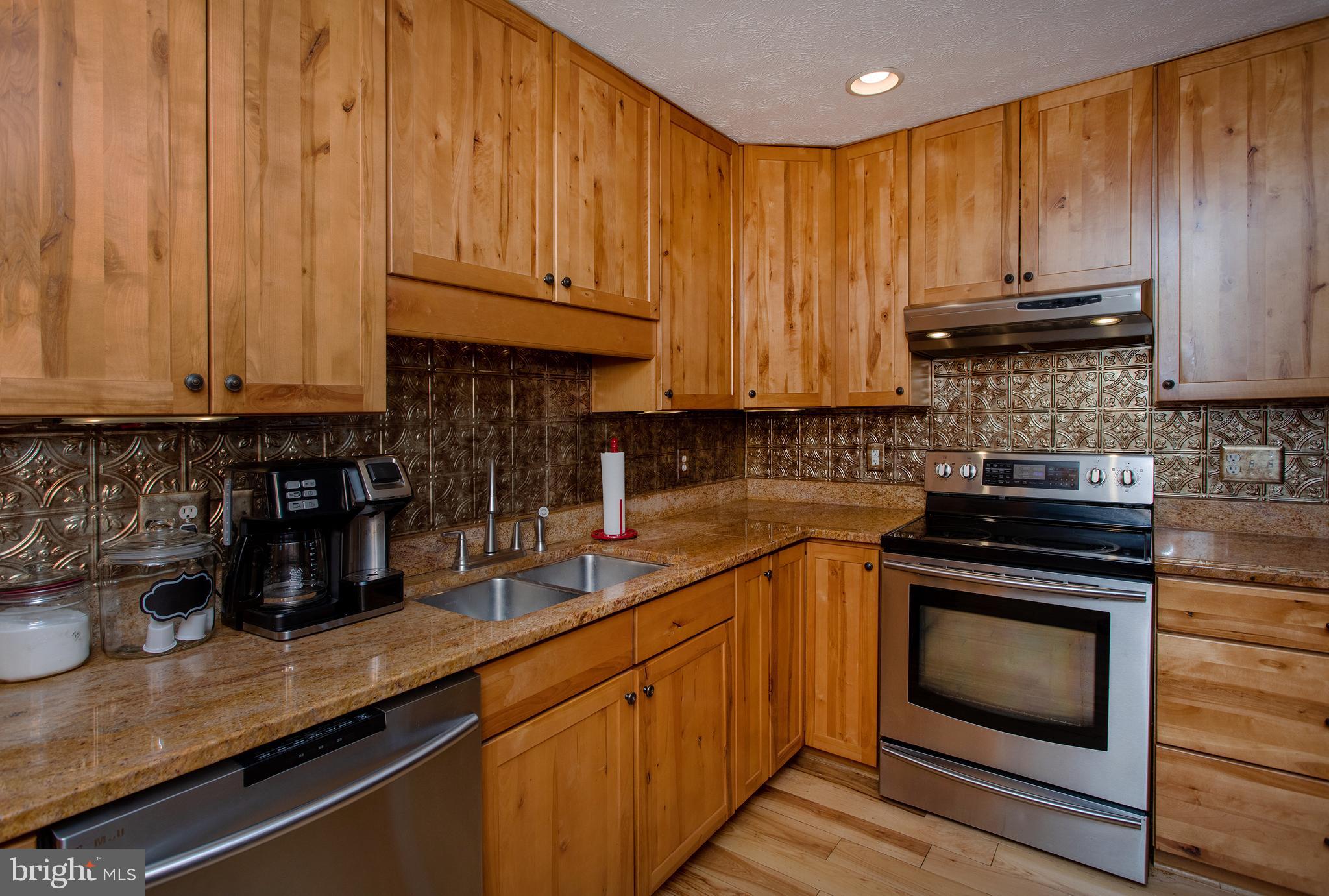 8305 Olivers Shop Road La Plata, MD 20646 - Photo 11 of 43 a kitchen with granite countertop wood cabinets and stainless steel appliances