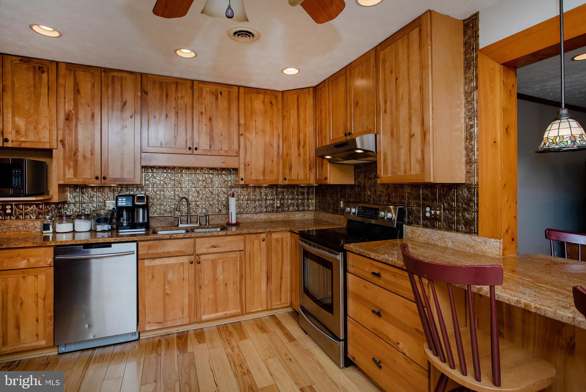 8305 Olivers Shop Road La Plata, MD 20646 - Photo 12 of 43 a kitchen with stainless steel appliances granite countertop wooden cabinets a stove top oven a sink and dishwasher