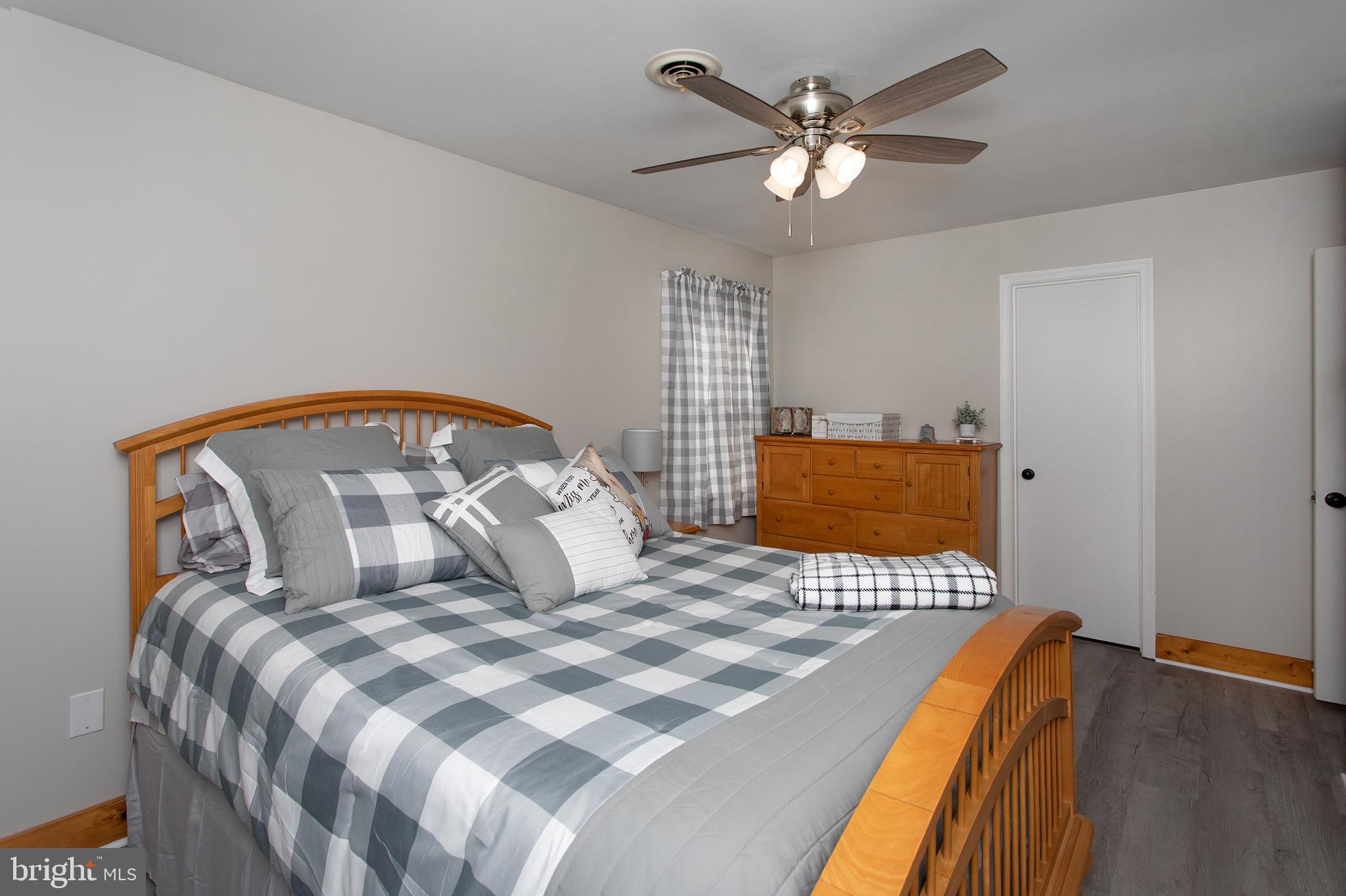 8305 Olivers Shop Road La Plata, MD 20646 - Photo 26 of 43 a bedroom with a large bed and a chandelier