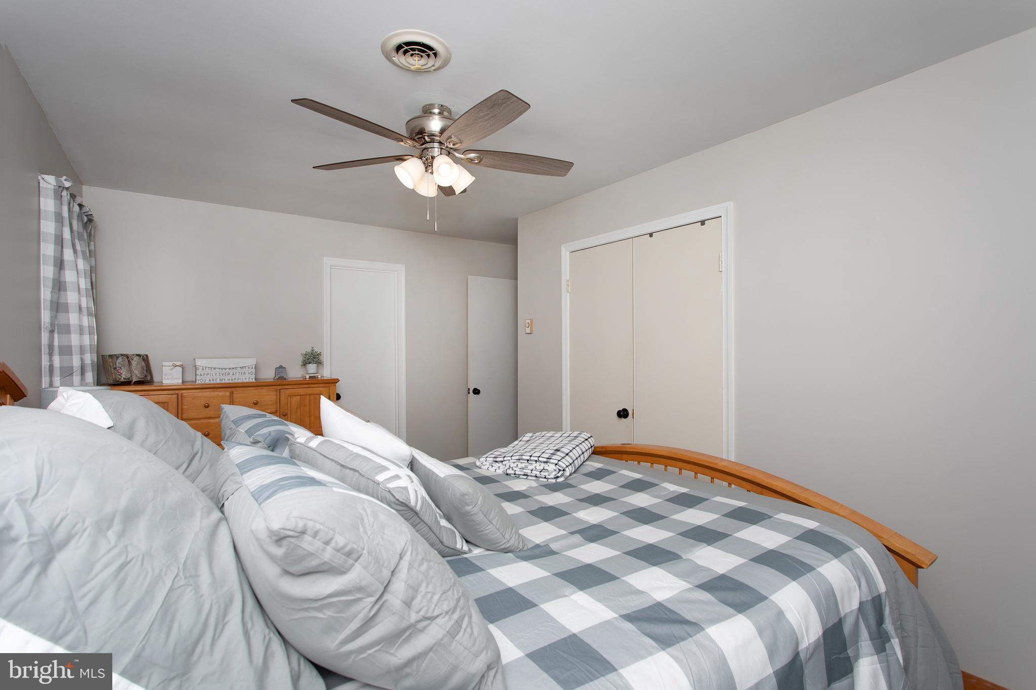 8305 Olivers Shop Road La Plata, MD 20646 - Photo 27 of 43 a bedroom with a bed and a chandelier