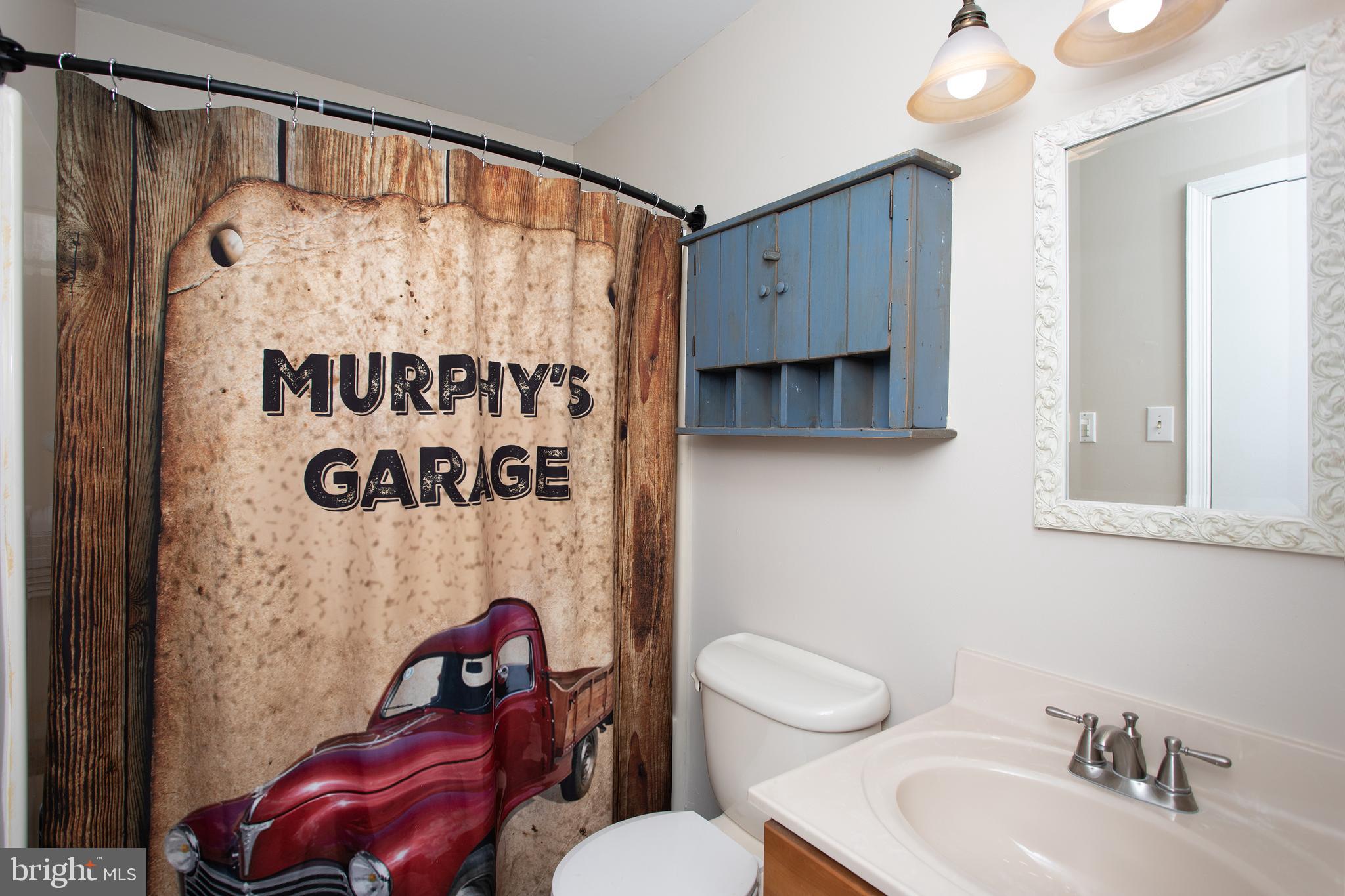 8305 Olivers Shop Road La Plata, MD 20646 - Photo 29 of 43 a bathroom with a toilet sink and mirror