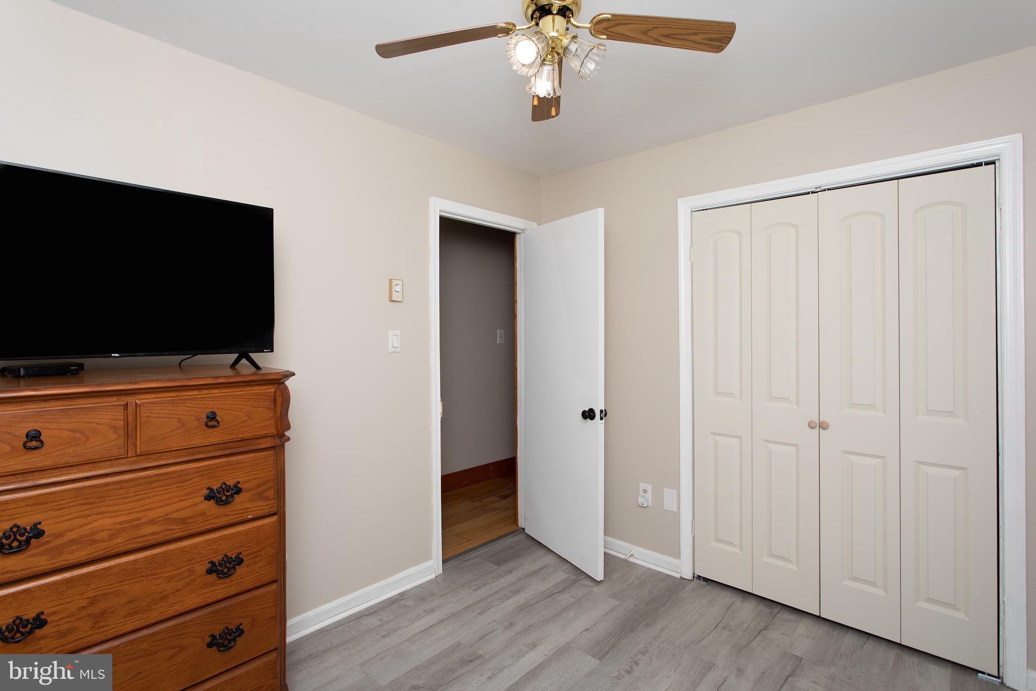 8305 Olivers Shop Road La Plata, MD 20646 - Photo 32 of 43 a view of room with wooden floor and ceiling fan