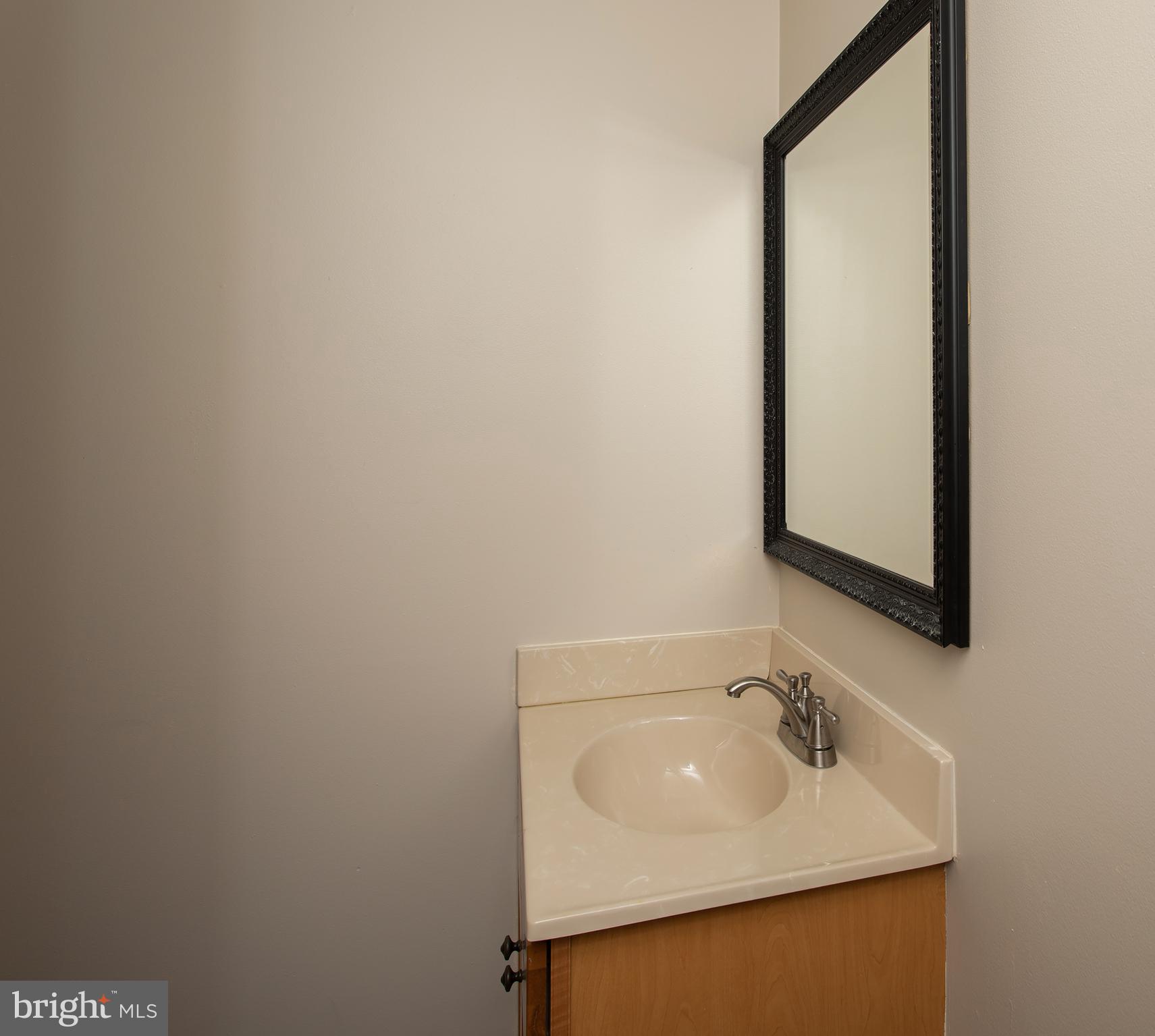 8305 Olivers Shop Road La Plata, MD 20646 - Photo 38 of 43 a bathroom with a sink and mirror