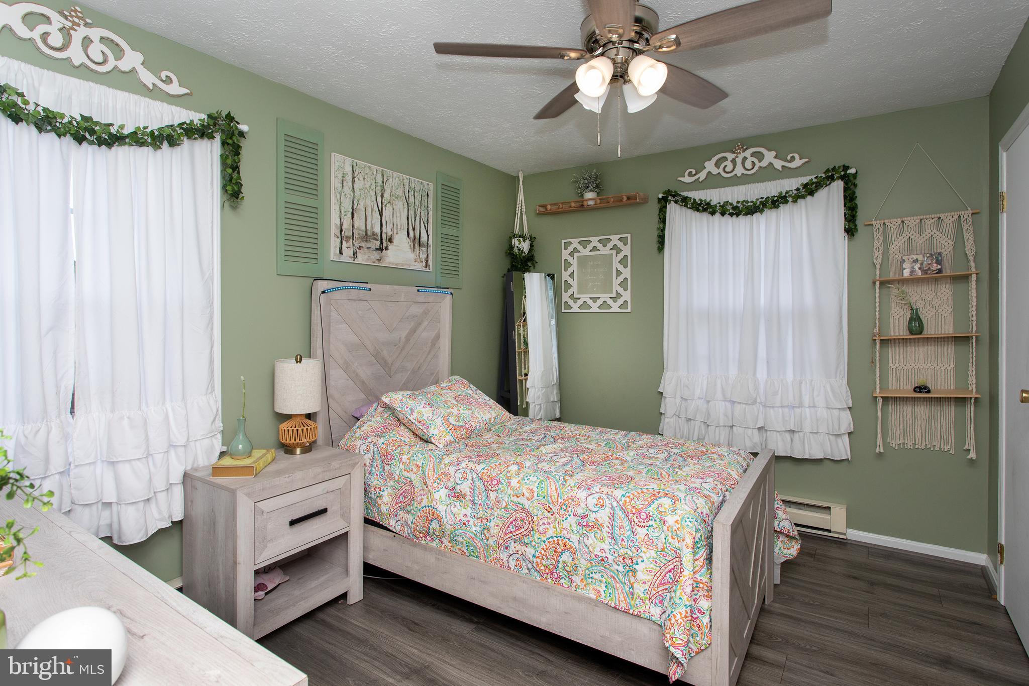 8305 Olivers Shop Road La Plata, MD 20646 - Photo 40 of 43 a bedroom with a bed and a chandelier