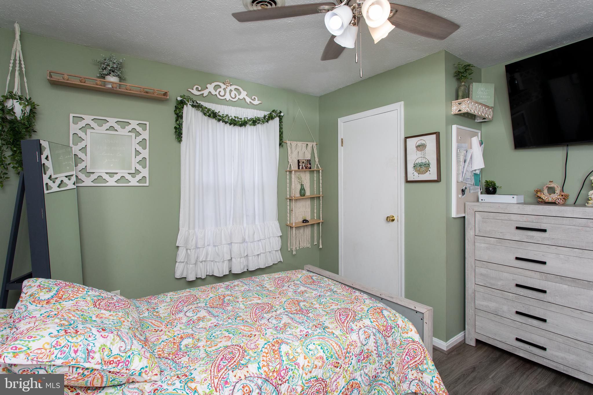 8305 Olivers Shop Road La Plata, MD 20646 - Photo 42 of 43 a bedroom with a bed and a flat tv screen on dresser