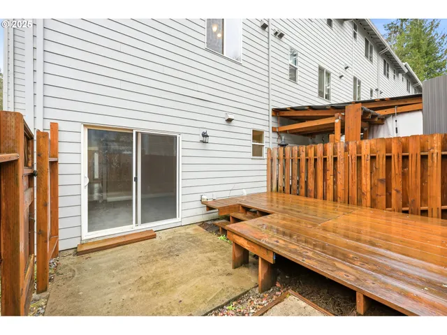 a backyard of a house with barbeque oven table and chairs