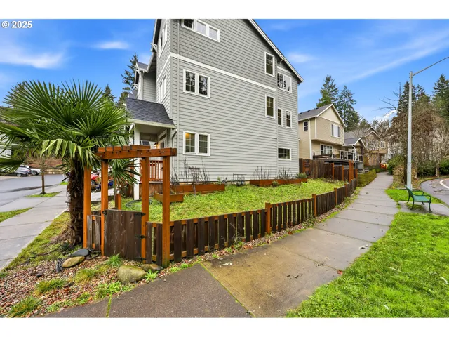 a view of a house with wooden fence