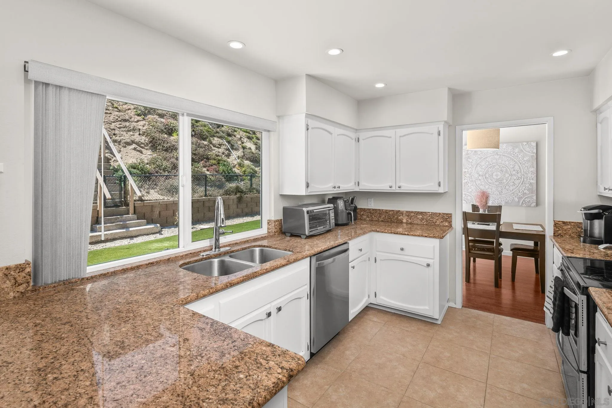 17078 Matinal Road San Diego, CA 92127 - Photo 7 of 41 a large kitchen with kitchen island a sink stainless steel appliances and cabinets