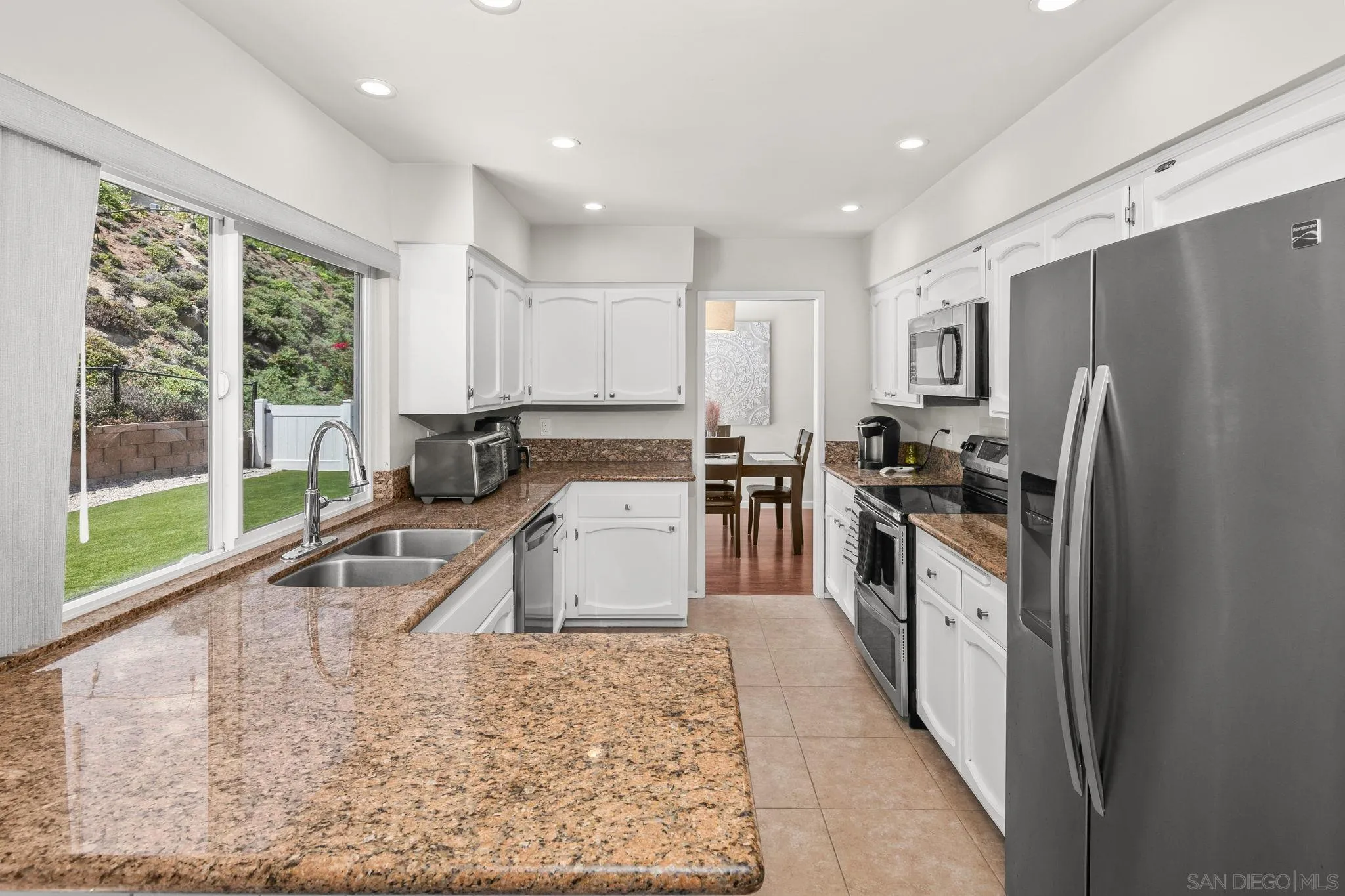 17078 Matinal Road San Diego, CA 92127 - Photo 8 of 41 a kitchen with refrigerator a sink and cabinets