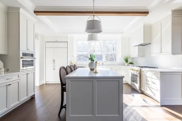 a kitchen with kitchen island granite countertop a sink and refrigerator