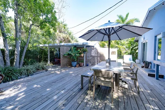 a view of patio with table and chairs under an umbrella
