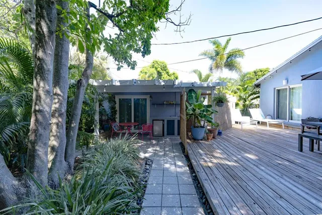 a view of a house with sitting area and garden