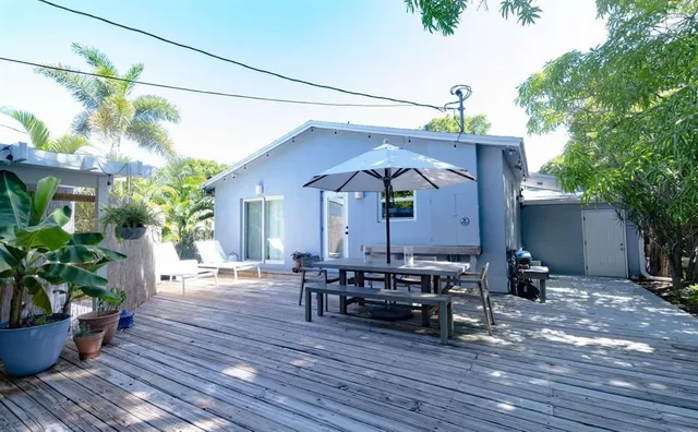 a view of house with wooden floor and outdoor seating